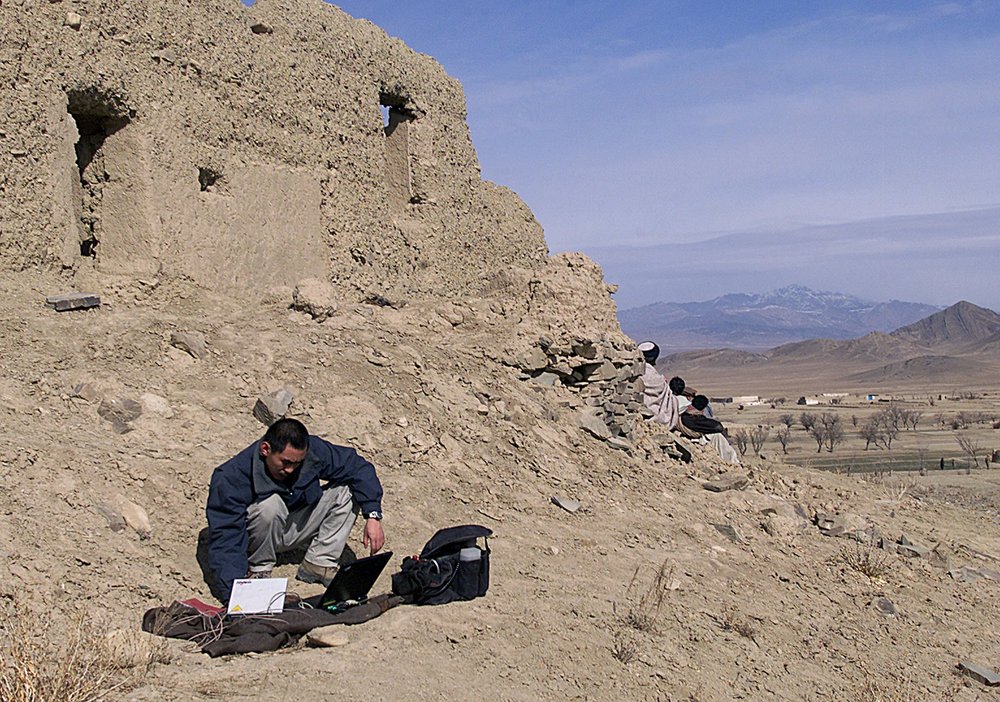 A person beside an earthen wall