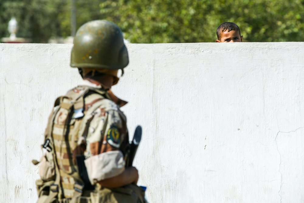 A soldier beside a wall
