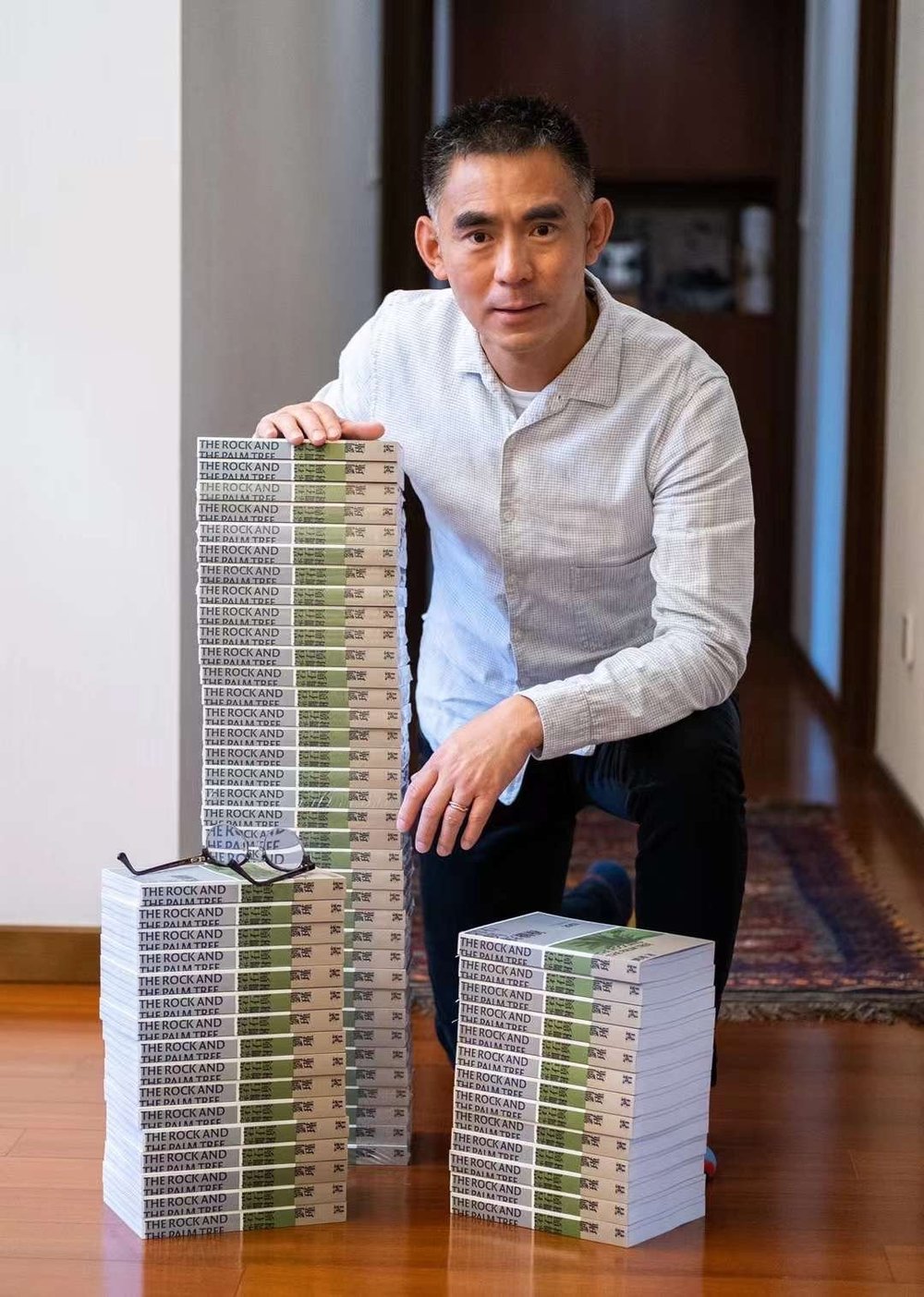 Liu Jin with copies of The Rock and the Palm Tree
